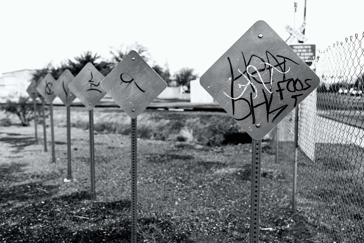 road sign greyscale photo of signages sign